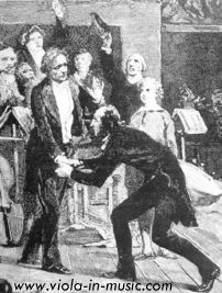 Paganini bows in front of Berlioz and kisses his hands